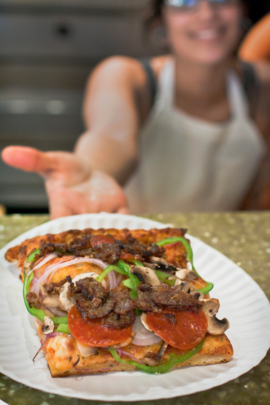 AlpersBrooklynPizza-277b Slice of pizza being served to me in a restaurant by Tucson food photographer Jackie Alpers