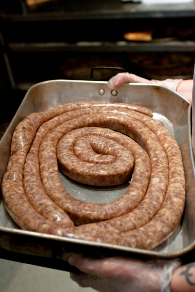 Preparing the sausage at Brooklyn Pizza.